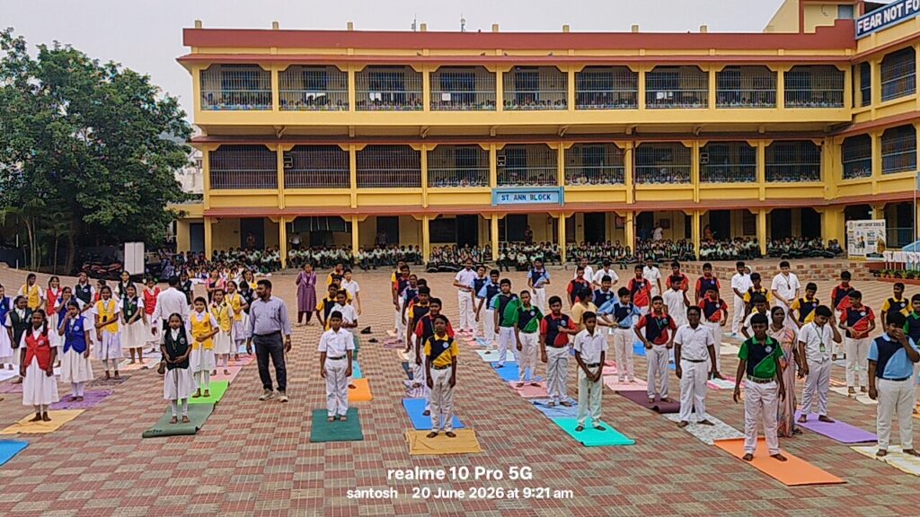 Students participating in Yoga Day celebrations at the school through a group yoga session.